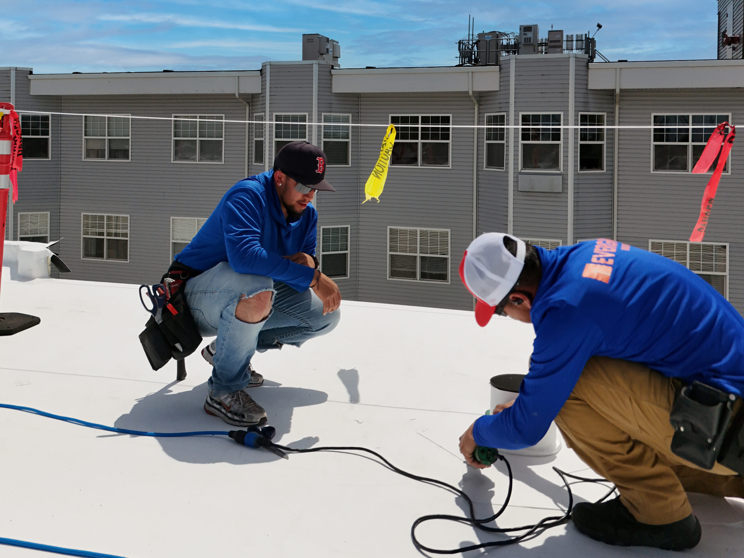 roofers working on a flat commercial roof
